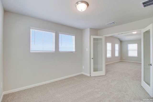 11583 Cottage Pt, San Antonio, TX 78254 - spare room featuring french doors, visible vents, and light carpet