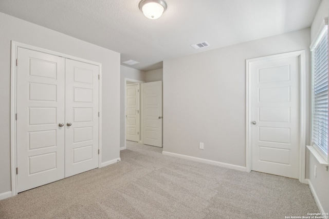 11583 Cottage Pt, San Antonio, TX 78254 - unfurnished bedroom featuring a closet, visible vents, carpet flooring, multiple windows, and baseboards