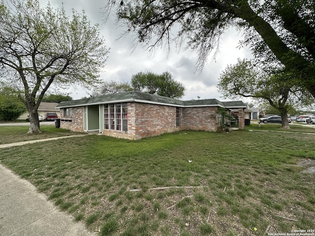 view of property exterior featuring a lawn and brick siding