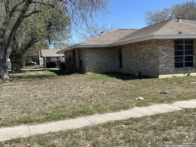 view of side of home with brick siding