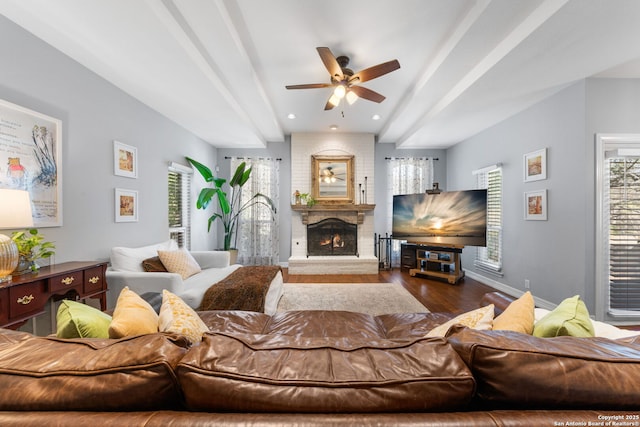 living room featuring wood finished floors, recessed lighting, baseboards, a brick fireplace, and ceiling fan