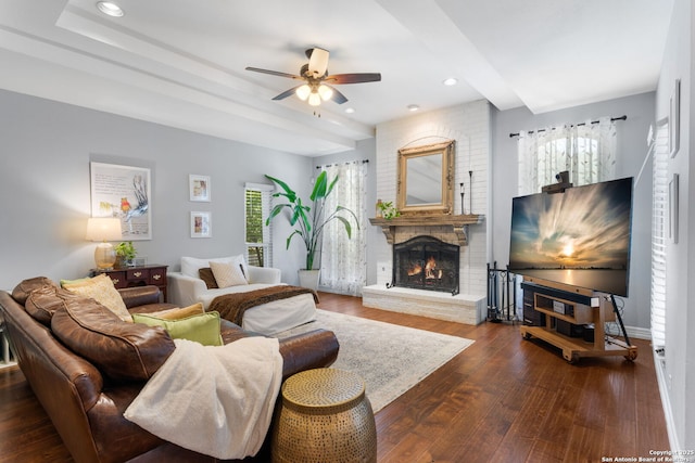 living room with a brick fireplace, baseboards, ceiling fan, hardwood / wood-style floors, and recessed lighting