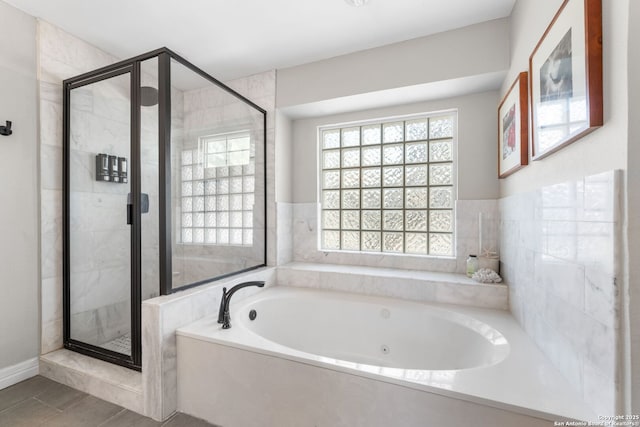 full bath featuring a garden tub and a stall shower