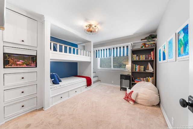 bedroom with baseboards and carpet