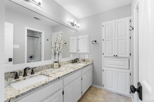 bathroom featuring a sink, visible vents, a shower, and tile patterned floors