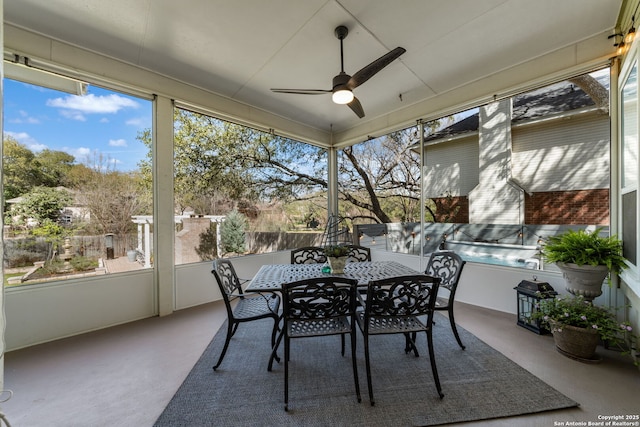 unfurnished sunroom with a wealth of natural light and ceiling fan