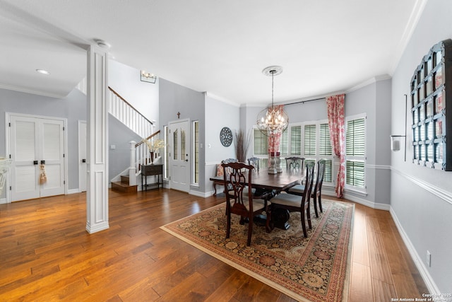 dining space featuring stairs, an inviting chandelier, wood-type flooring, and ornamental molding