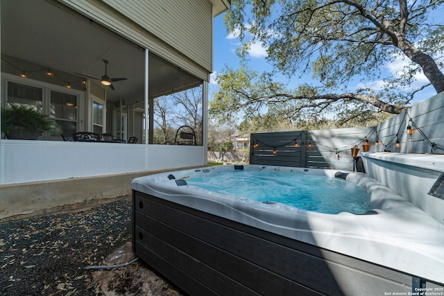 view of pool featuring a sunroom, ceiling fan, and a hot tub