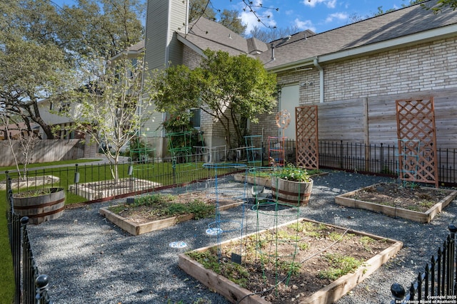 view of yard featuring a vegetable garden and fence