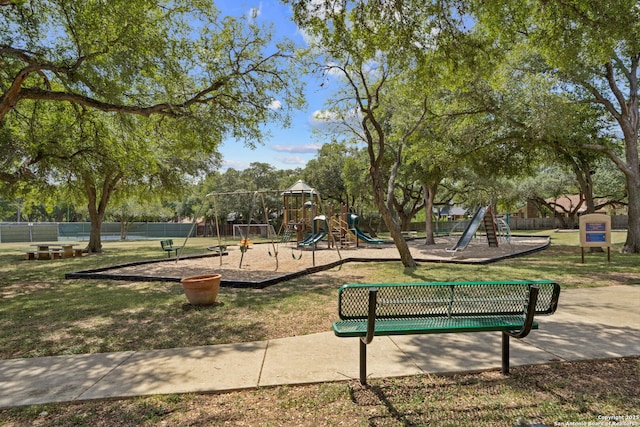 surrounding community featuring playground community, a yard, and fence