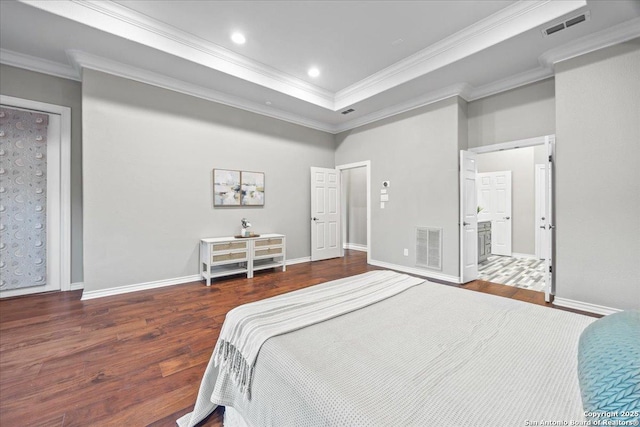 bedroom with visible vents, crown molding, baseboards, and wood finished floors