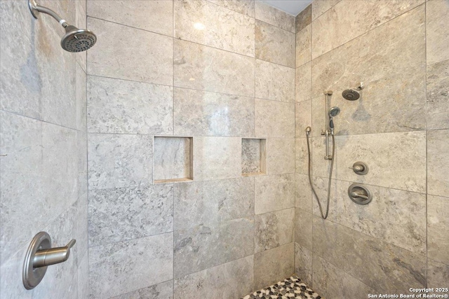 interior details featuring tiled shower