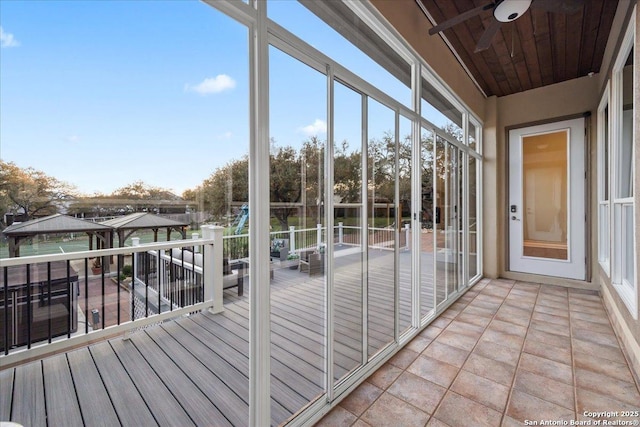 unfurnished sunroom with plenty of natural light and wood ceiling