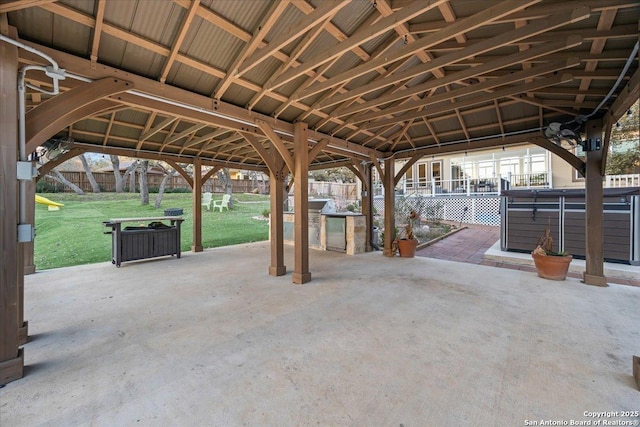 view of patio / terrace with a gazebo, fence, and a hot tub