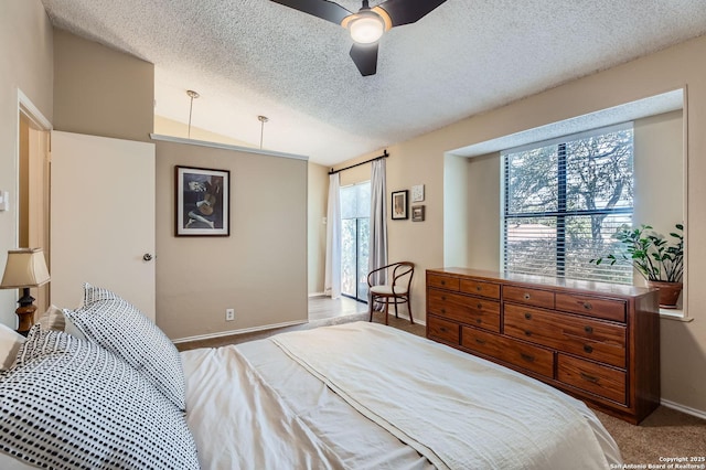 bedroom with a ceiling fan, baseboards, a textured ceiling, and carpet flooring