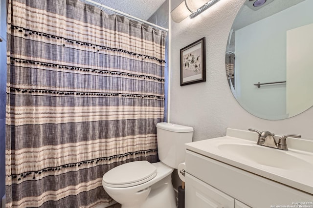 full bath with vanity, a shower with curtain, a textured ceiling, toilet, and a textured wall