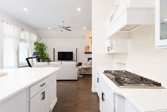 kitchen featuring light countertops, white cabinets, a ceiling fan, and stainless steel gas cooktop