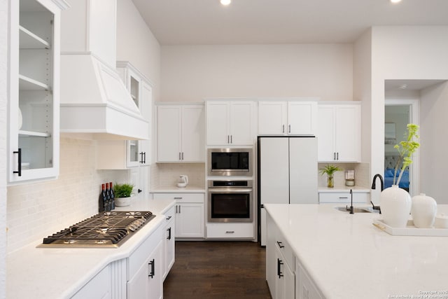 kitchen with a sink, light countertops, white cabinetry, and stainless steel appliances