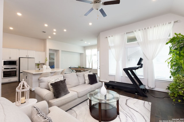 living area with dark wood finished floors, recessed lighting, visible vents, and a ceiling fan