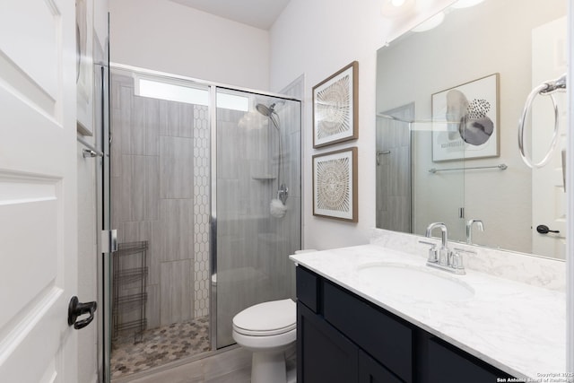 full bath featuring vanity, toilet, and a stall shower