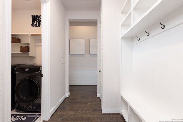 laundry room featuring laundry area, washer / dryer, dark wood-type flooring, and baseboards