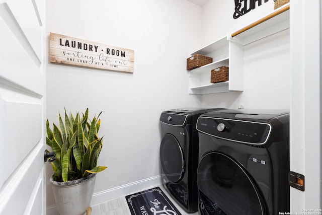 laundry room featuring baseboards, laundry area, and washer and clothes dryer