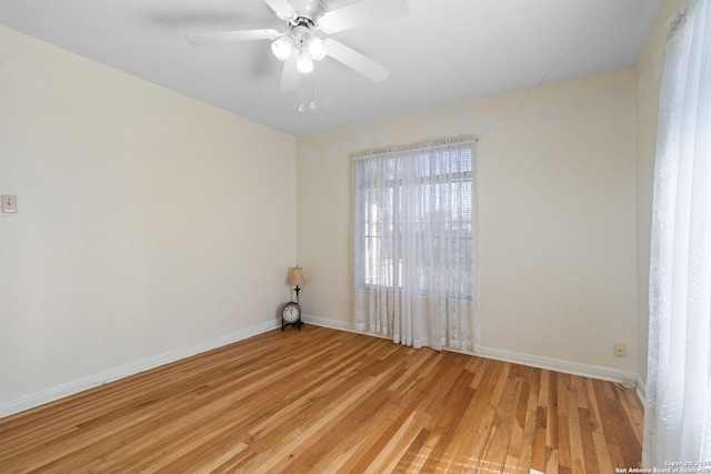 empty room with light wood-style floors, baseboards, and ceiling fan