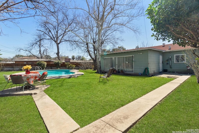 view of yard with a fenced in pool, a fenced backyard, and a patio area