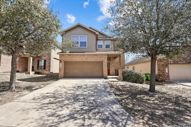 traditional home featuring a garage, brick siding, and driveway