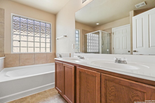 bathroom featuring a sink, visible vents, a shower stall, and tile patterned flooring