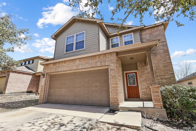 traditional home with a garage, brick siding, and driveway