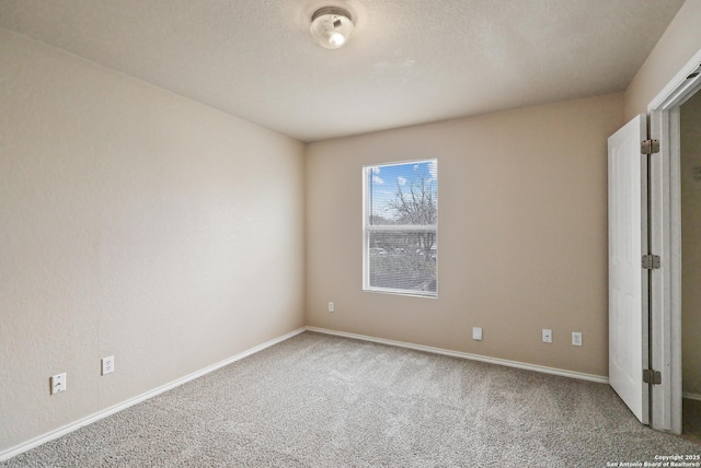 unfurnished bedroom with baseboards, carpet floors, and a textured ceiling