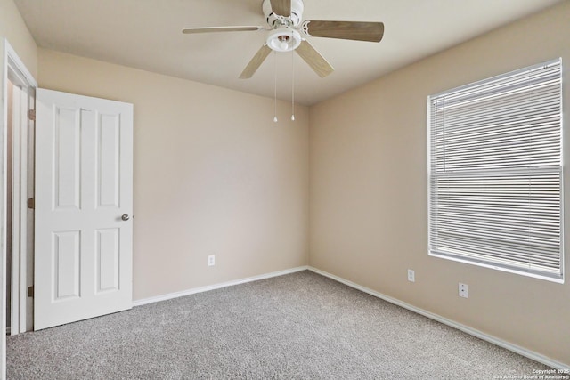 unfurnished room featuring carpet flooring, a ceiling fan, and baseboards