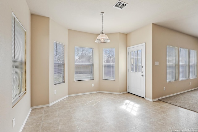 unfurnished dining area featuring light tile patterned floors, baseboards, and visible vents