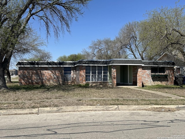 mid-century modern home with brick siding