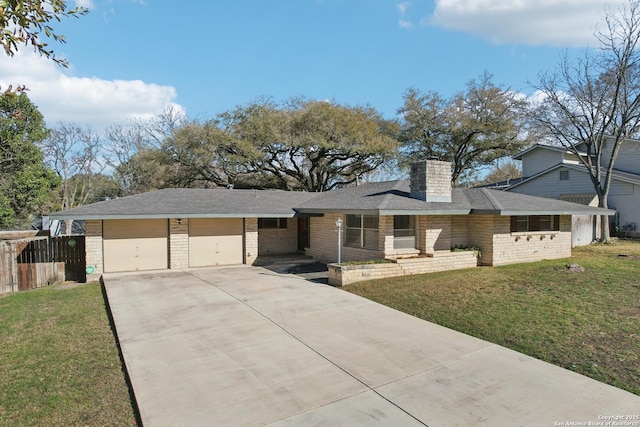 view of front facade featuring fence, driveway, a chimney, a front lawn, and a garage