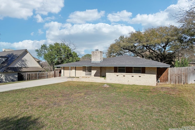 ranch-style home featuring a chimney, concrete driveway, a front yard, and fence