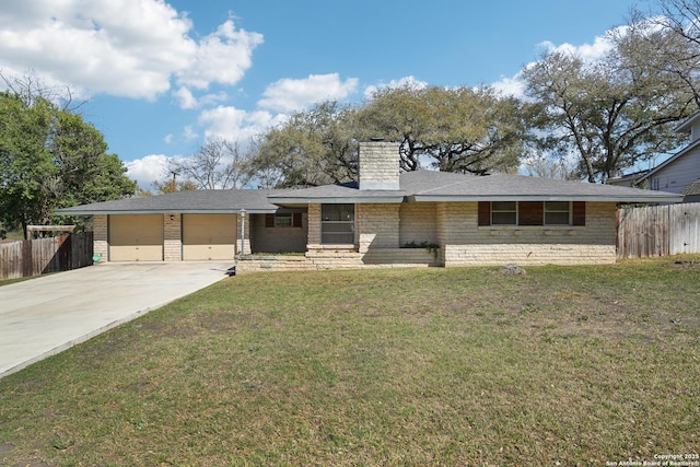 view of front facade featuring a garage, a chimney, a front yard, and fence