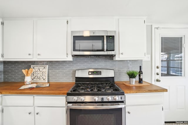 kitchen featuring backsplash, white cabinets, and stainless steel appliances