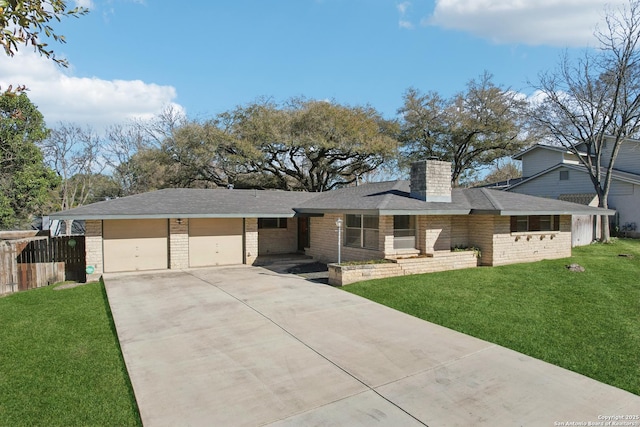 view of front facade featuring a front lawn, fence, a chimney, a garage, and driveway