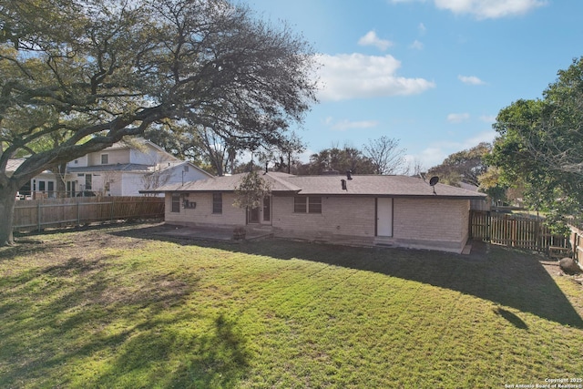 rear view of property featuring a fenced backyard, entry steps, a yard, and a patio