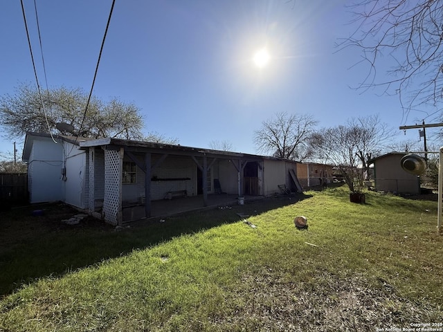 back of house with a patio and a yard