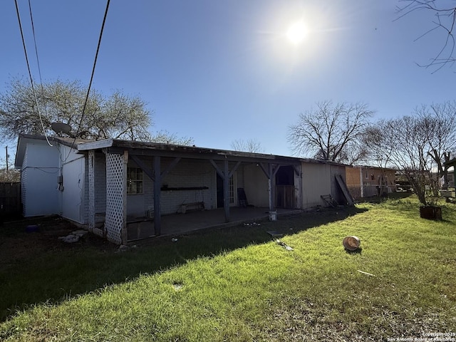 rear view of house with a lawn and a patio area