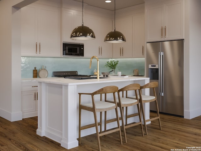 kitchen featuring a center island with sink, dark wood finished floors, white cabinetry, high quality fridge, and black microwave