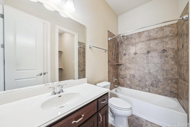 bathroom with toilet, vanity, and bathtub / shower combination