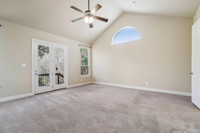 carpeted empty room with baseboards, visible vents, high vaulted ceiling, and a ceiling fan