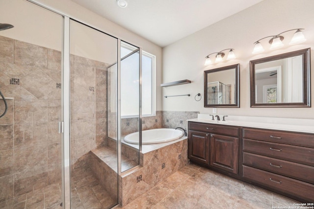 full bathroom with vanity, a bath, and a shower stall