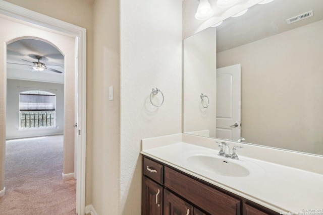 bathroom with baseboards, visible vents, vanity, and a ceiling fan