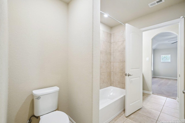 full bathroom featuring visible vents, baseboards, toilet, shower / bath combination, and tile patterned floors