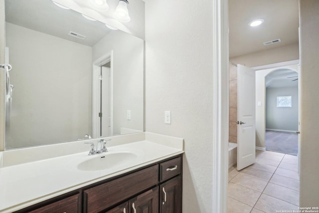 full bathroom with tile patterned flooring, vanity, visible vents, and baseboards